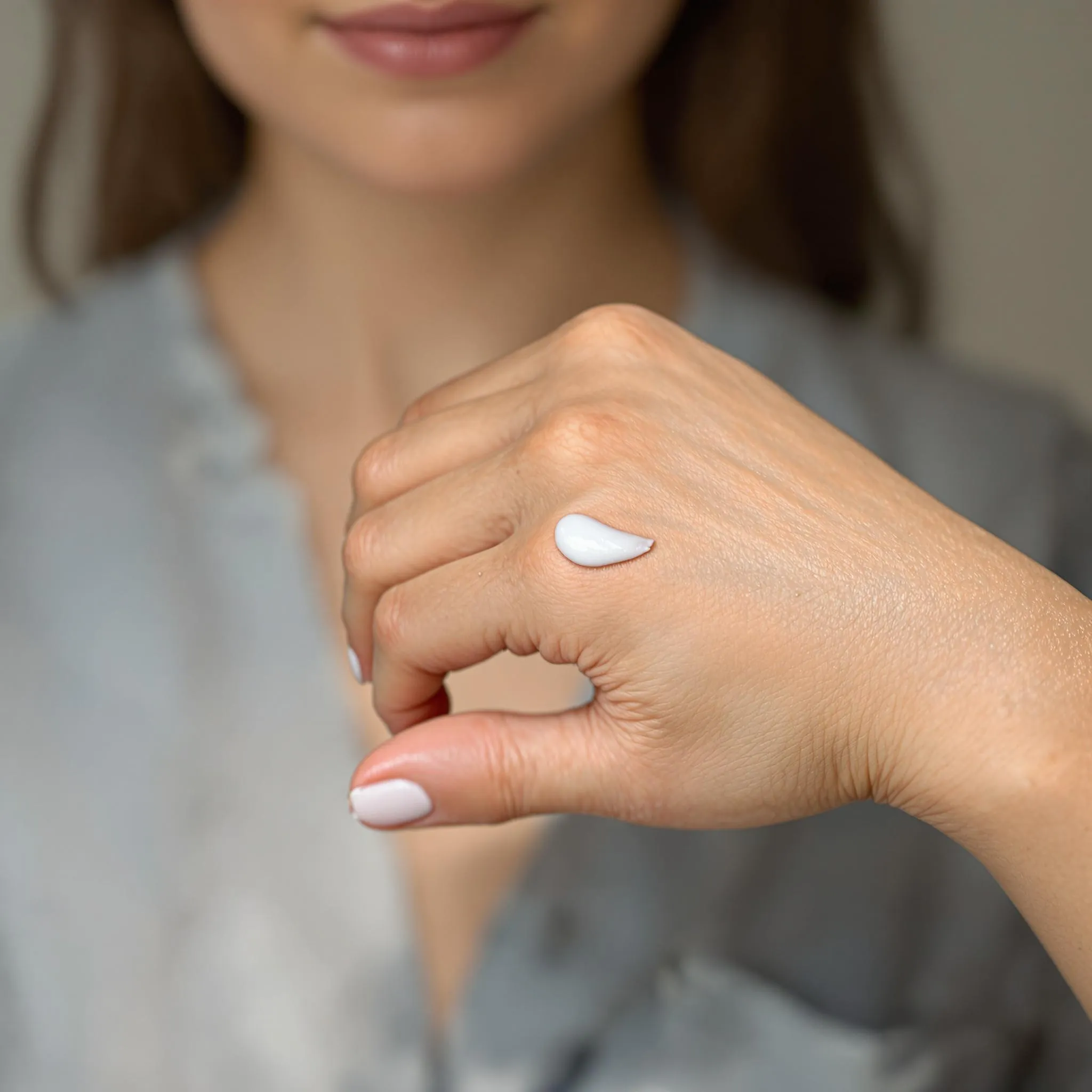 A hand with a small amount of cream applied, representing the application of CBD cream for topical use.