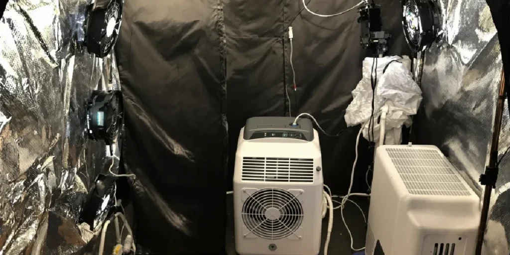dehumidifier and ventilation system setup inside indoor grow tent for humidity control