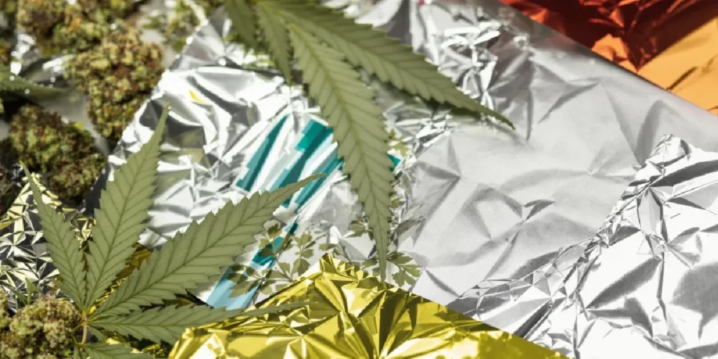 Cannabis buds and leaves with aluminum foil as alternative smoking method.