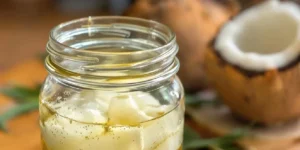 Cannabis buds being heated in pot for coconut oil infusion process