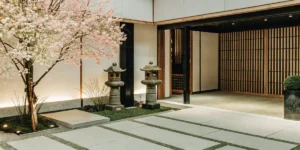 vibrant cherry blossom tree with stone lanterns in a serene japanese-style garden